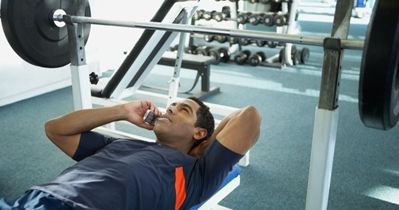 Talking on a cell phone while using the bench press