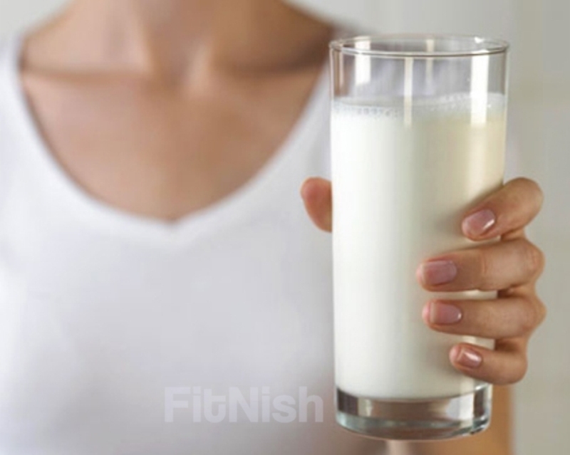 Woman holding a glass of organic milk