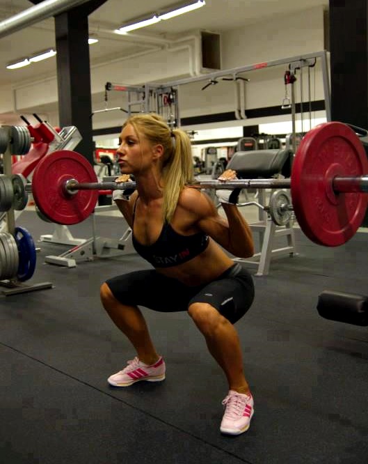 Fit girl squatting