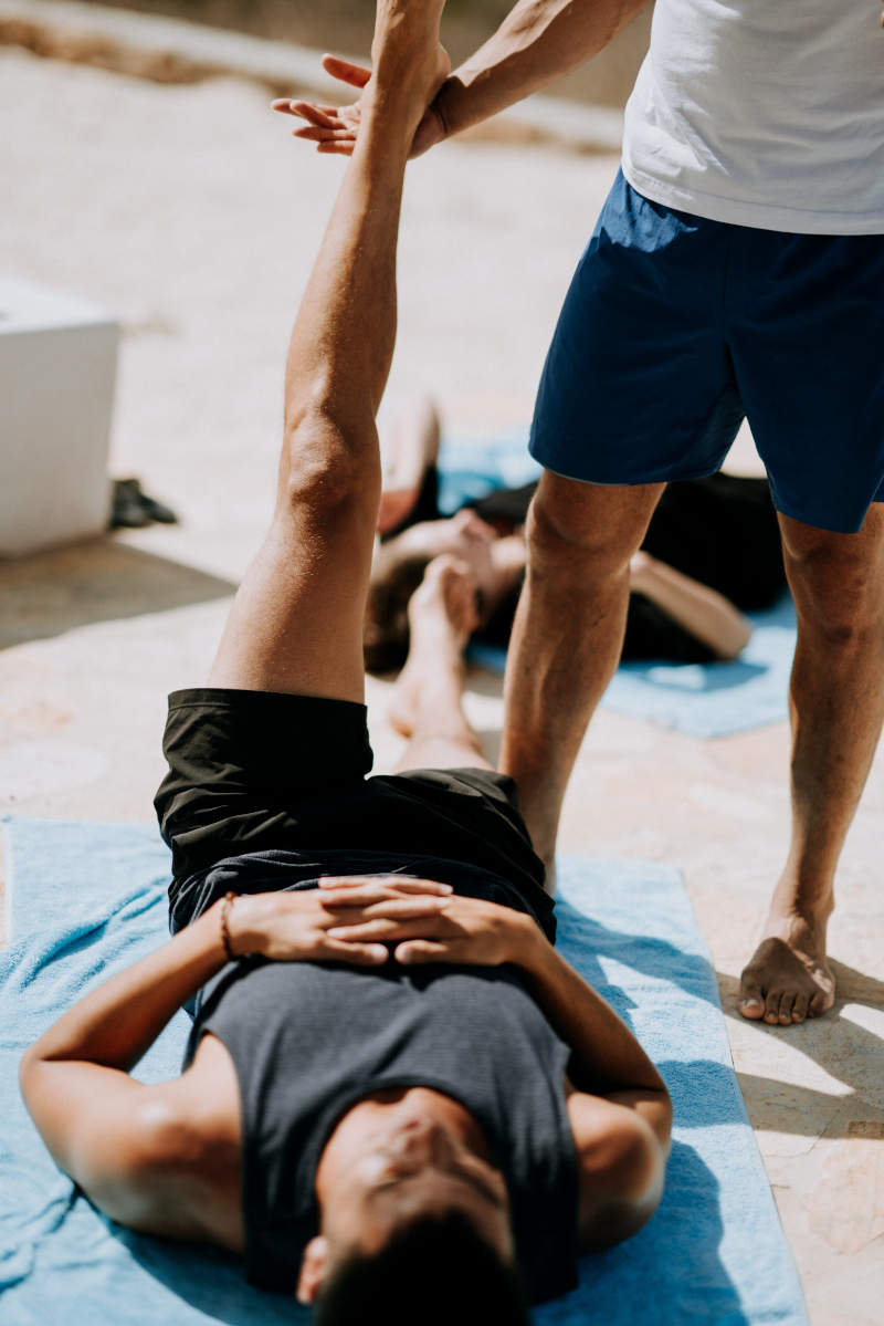 yoga teacher stretching